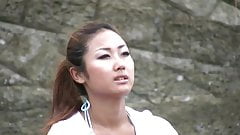 Pretty young brunette takes a walk on the beach