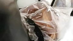 Girl in Rubber with Bag on Head and Vibrator