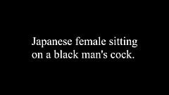 Japanese female sitting on a black man’s cock.